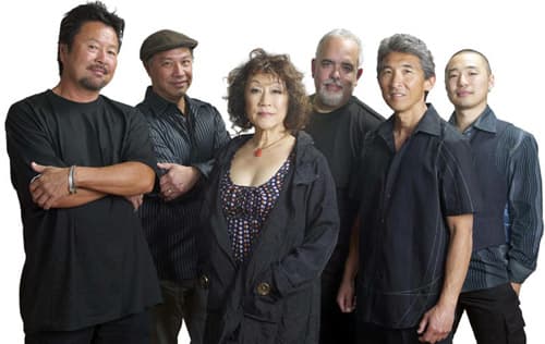 If you already listened to Hiroshima's music, you will know that they combine smooth jazz with the natural sound of the koto (a long Japanese multi-stringed instrument), which is performed by June Kuramoto. Hiroshima's multi-instrumentalist and co-fo