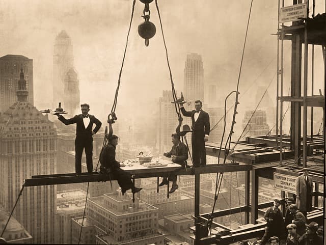 This stunt by the early Waldorf Astoria Hotel in New York City became a real dining experience in the 2010s. Notice the ironworkers in the lower lefthand corner of the photo.