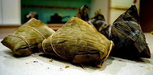 Zongzi, made of glutinous rice stuffed with various fillings and wrapped in bamboo leaves, eaten during Dragon Boat Festival period
