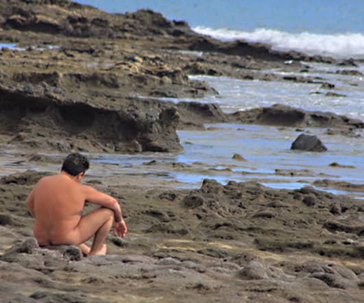 The all-over tan at Caleta del Congrio. However I'm not sure that sitting on those sharp-edged rocks looks to be quite as comfortable as sitting on the sand
