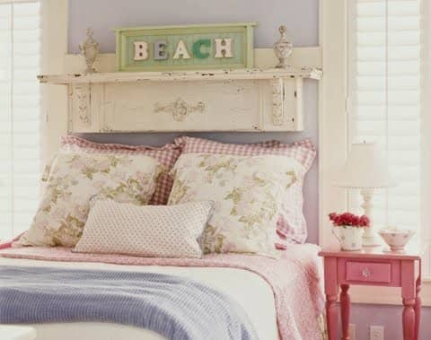 mini-shelf or plate rail above a bed holding a country cottage chic plate for coastal charm - labelled beach