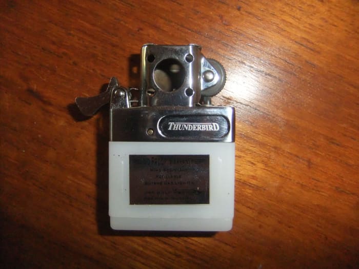 Cam Lever (on left of lighter) down, as it would be when the lid is open, releasing the butane for use