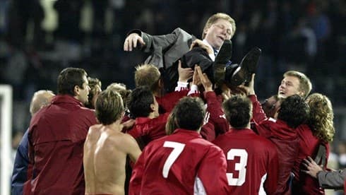 Players and other personnel celebrate by hoisting Latvian manager Aleksandrs Starkovs after Latvia secured a berth at Euro 2004 with a 2-2 draw on Nov. 19, 2003.