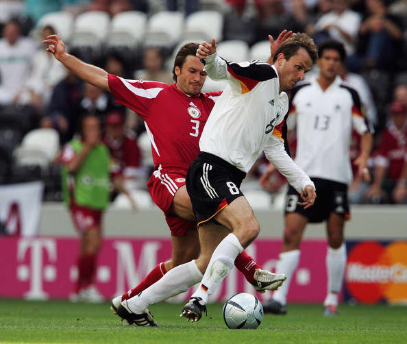 Latvia's Vitalijs Astfjevs battles for the battle with Germany's Dietmar Hamann during a Euro 2004 match in Porto, Portugal. This match was one of 167 appearances for Astafjevs, the most by a European player.