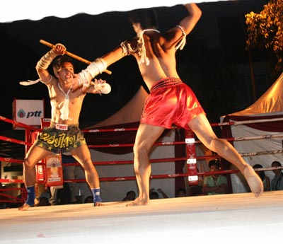 Krabi Krabong stick fighting with Muay Thai shorts and Muay Boran wrappings. In Ancient times, Muay Boran and Krabi Krabong was used in warfare.