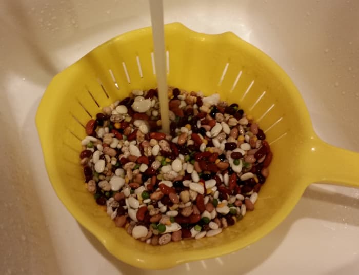 Run water over them, stirring so all are rinsed. Some of the beans are quite tiny so use a colander with small openings so they don't escape.