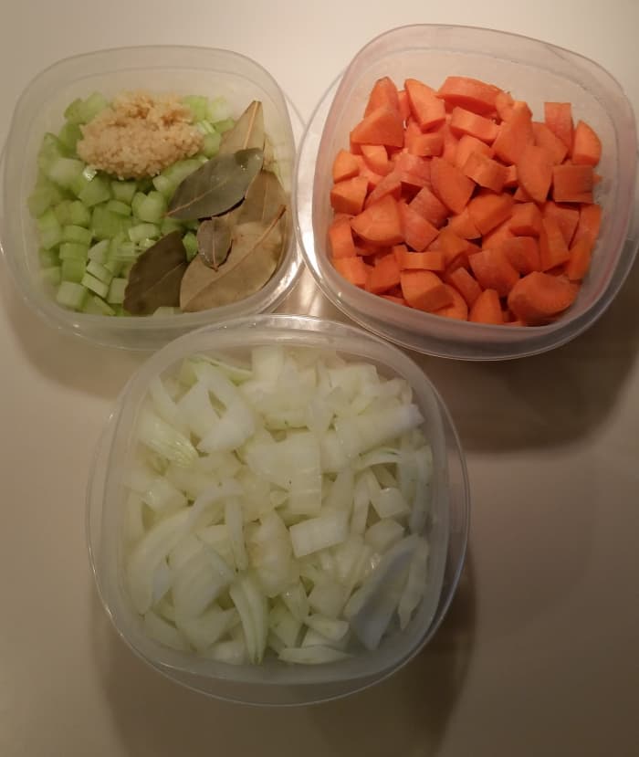 This shows the chopped carrots, chopped celery, chopped onions, some bay leaves and some chopped fresh garlic cloves.