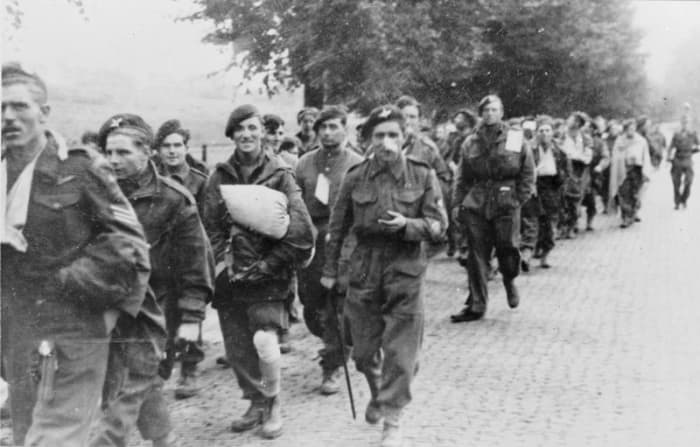British paratroopers led away as POWs were subjected to physical abuse on their way to camps in the east,. long hours spent entrained without food or water - two and a quarter thousand reached safety back across the Rhine