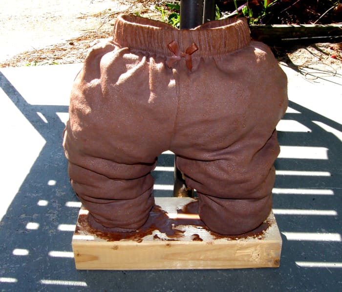 I have placed the sculpture in the sun for faster drying. It is leaning up against a chair for support while it dries. The plastic bags inside create the look and feel of the wrinkles while it dries, plus supports the item.