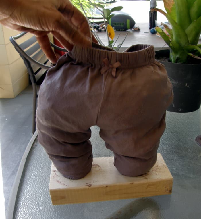 I chose a board for the base. The pants is completely stuffed here and positioned on a board where it will be staged permanently.