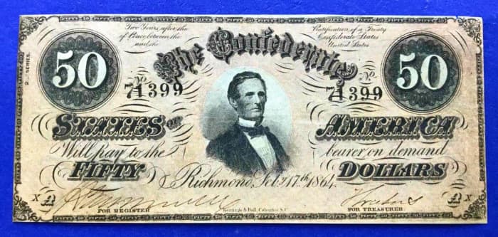 1864 In Light Pink $50 Confederate States of America Currency. The green highlights are not in the later fifty dollar CSA currencies ... and the serial numbers are stamped, and not handwritten.