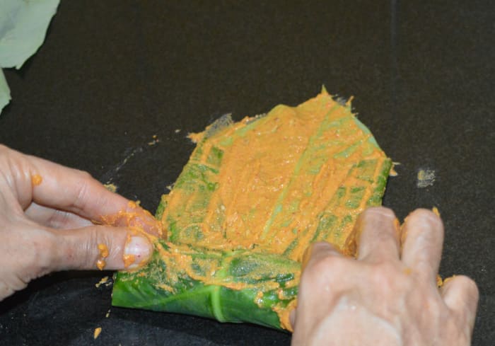 Step three: Fold the sides and the bottom up to 2 inches and apply the paste on the exposed areas. Hold the bottom portion tightly with your both hands and make roll as shown in the pic. Apply the paste to the exposed areas.