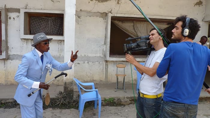 Sapeurs love publicity; here a member of the stylish community in Brazzaville is interviewed by Spanish television.