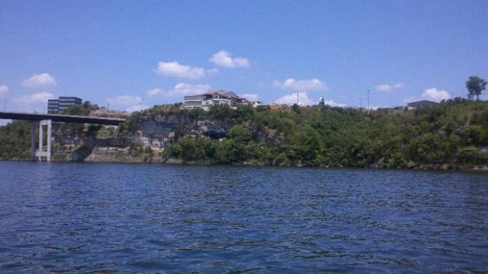 Boat-view of the bluffs where the winery is located. The large white building is JB Hooks, a popular restaurant. The winery is to the right but unable to be seen.