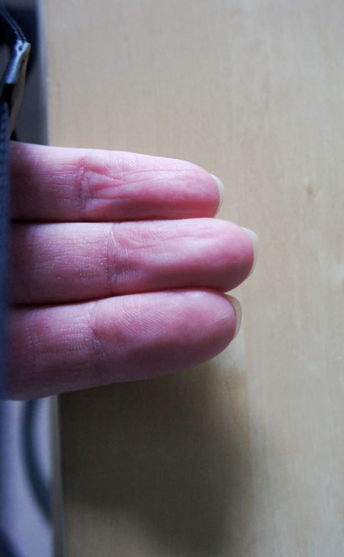 You should just see the nails popping over the top of the fingers. Notice how they are filed to one side.