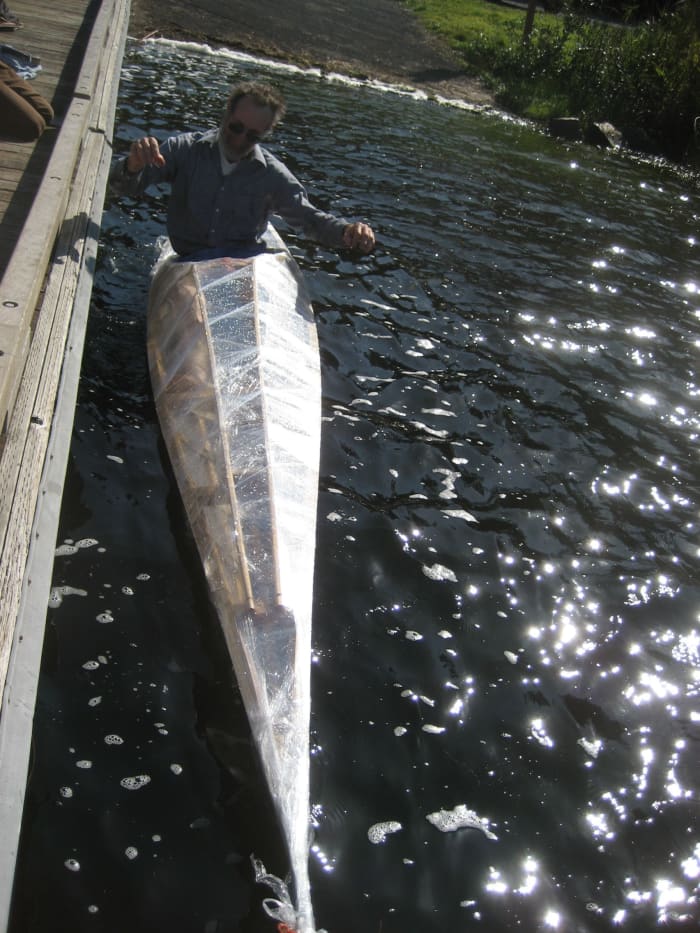 Builder testing his Greenland kayak - hip-wiggle to test balance/secondary stability. This authentic Greenland kayak is a low-profile hunter's kayak, 'tippy' for beginners but lighweight and responsive for an expert paddler.