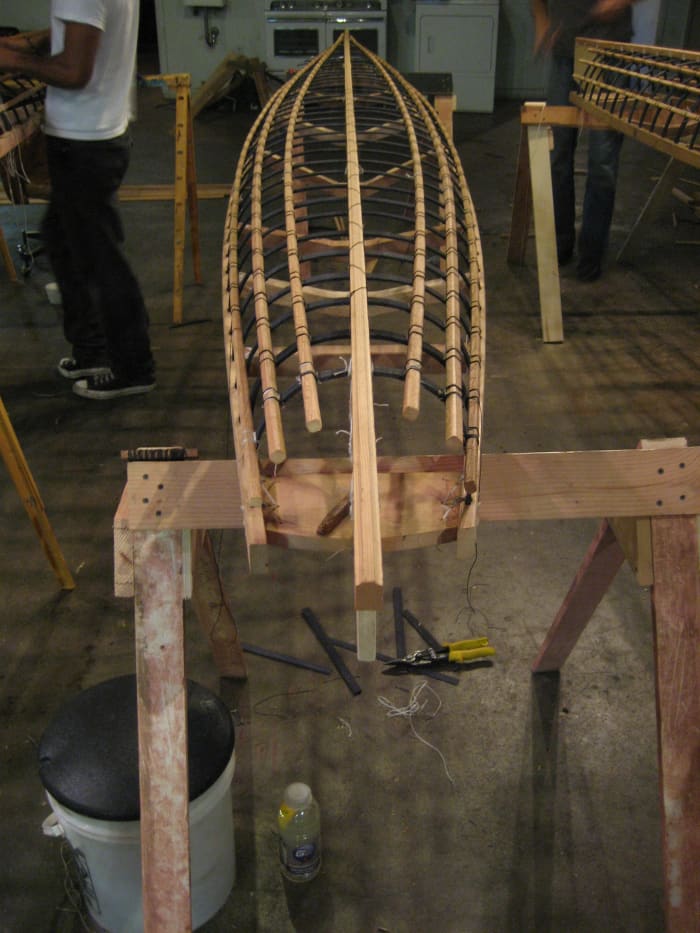 Fairing the boat - is the keel straight? Longs and gunnels symmetrical? Does it "look right"? This baidarka is a popular design originally from the Siberia/Bering sea area; it is a good long-distance kayak and not bad for novice paddlers.