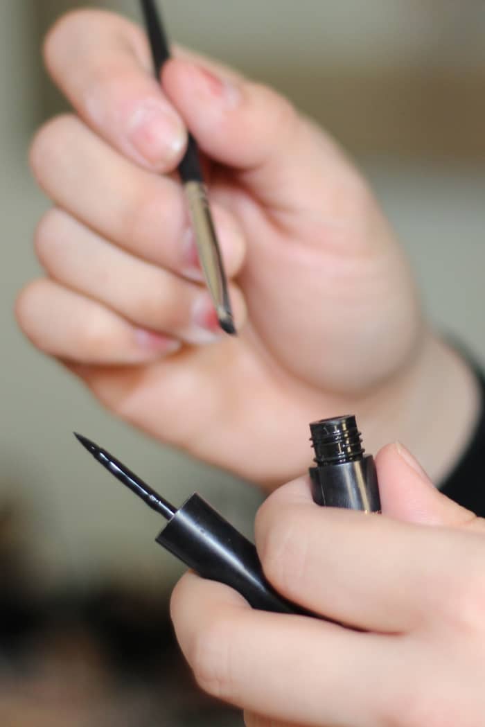 An angled brush and liquid eyeliner.
