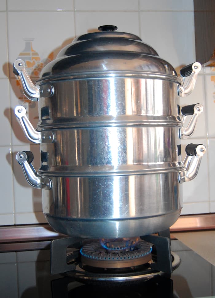 This is an inexpensive 2-tier steamer made of aluminum. The stainless steel steamers are expensive. The bottom unit holds the boiling water which produces the steam.