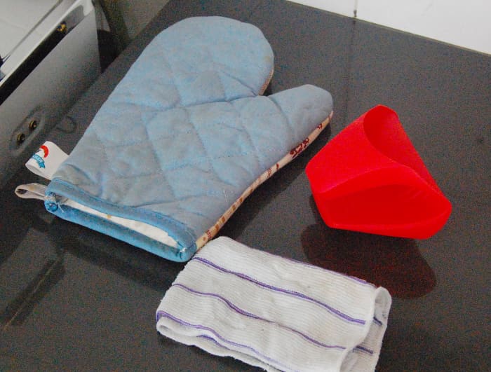 An oven glove, a rubberized finger glove or a moist kitchen keep your fingers from getting steam burn