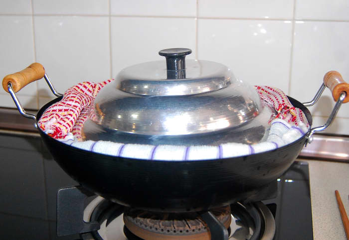 Use moistened clean kitchen cloth and place them firmly around the steamer, covering the gap between the steamer cover or lid and the wok to keep steam from escaping.