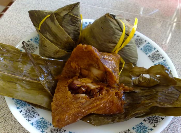 Glutinous rice with meat, mushroom and beans wrapped in bamboo leaves and steam cooked to perfection.