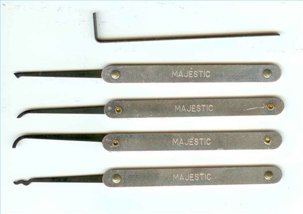 The top tool is the tension wrench. This is what your paper clip will need to resemble. The others are various lock picks.