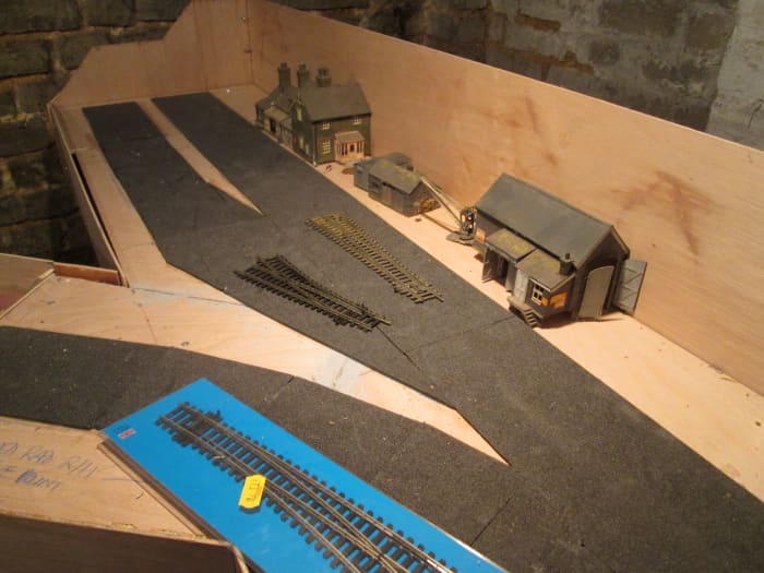 The furthest reaches of Unit 6, with foam underlay (from Carrs) where track is to be laid. Platform and structure edges will be based on the foam. Buildings 'recycled' from the ;Kirkrigg' layout.