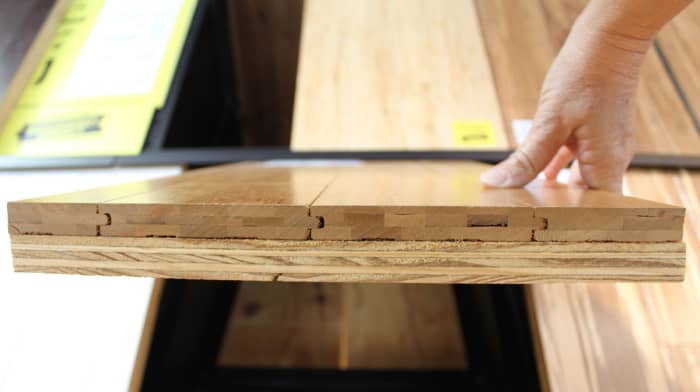 This is the edge of a flooring sample of solid horizontal bamboo mounted on a piece of plywood. Notice how the bamboo planks are 3-ply.