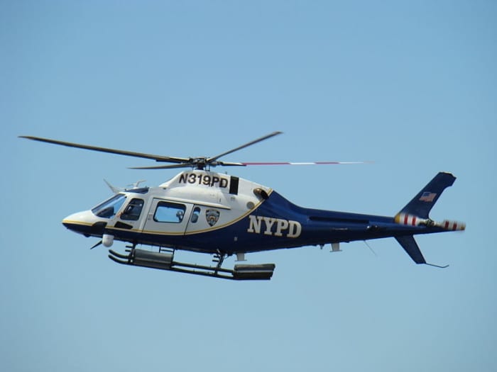 NYPD helicopter patrolling New York City. 29 May 2008. Barretta .50 caliber machine guns have been mounted on some NYPD helicopters to shoot down terrorist aircraft.