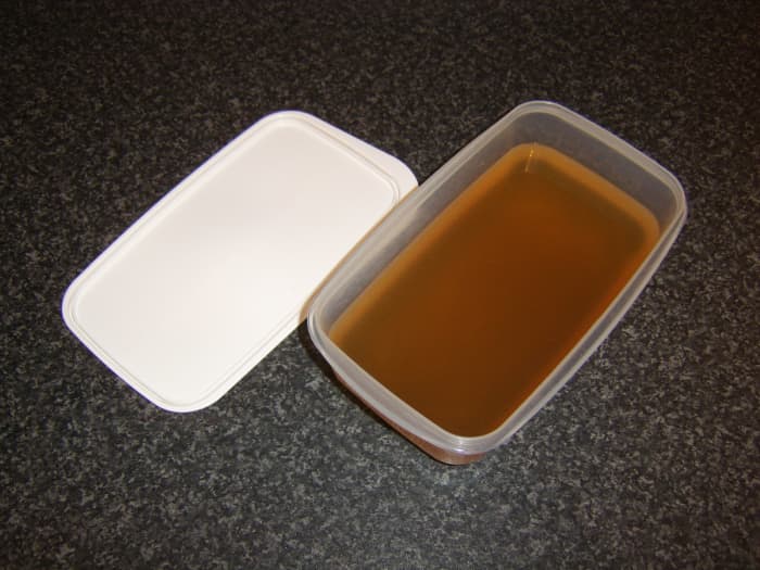 Fish stock should be poured in to a plastic dish with a lid before either being refrigerated or frozen