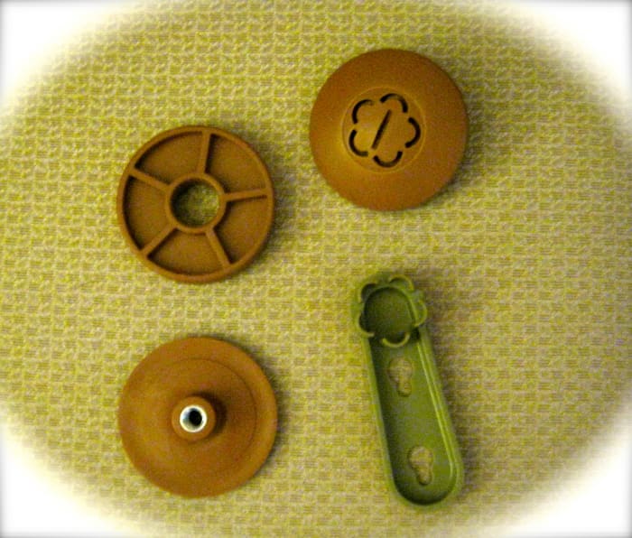 Parts included, clockwise from top left: spacers; top cap; magic wrench; bottom cap.