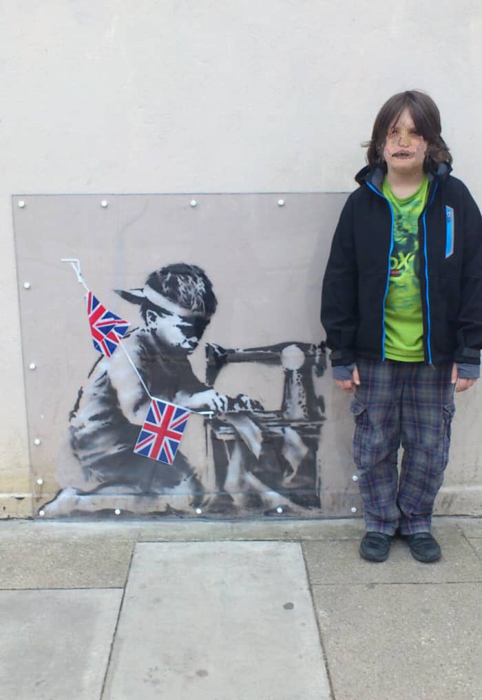 This was painted on the side of a cut-price superstore to underline the fact that we buy cheap clothes sourced from factories abroad that use child labour