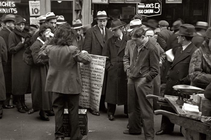New York, November 1936. Hair tonic salesman advertising his wares 'Joe's Egg Cream', Seventh Avenue at 38th Street.