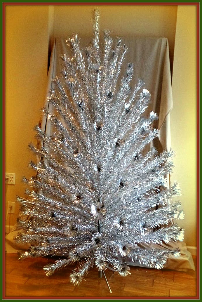 Early 1960s Peco Seven foot Aluminum Christmas Tree with 151 Pom Pom end branches. Very good used condition; complete with all 151 branches, 151 paper sleeves, two trunk poles, pole joining pin, & metal stand.