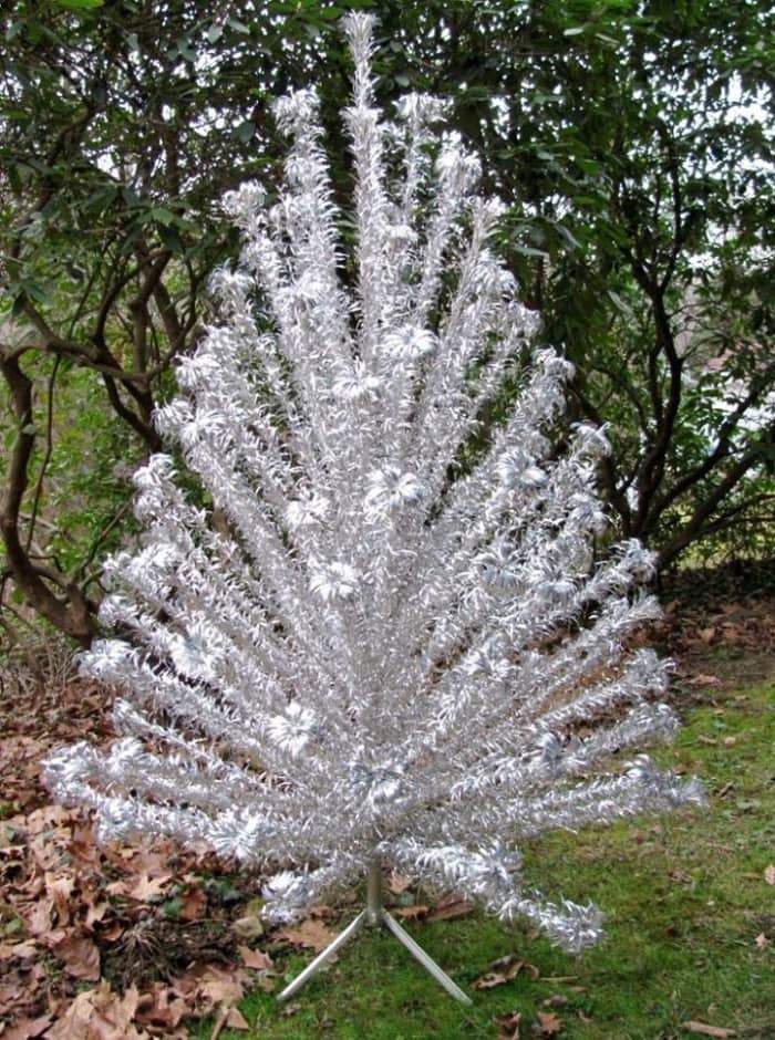 Evergleam Aluminum Christmas Tree manufactured by the Aluminum Specialty Company of Manitowoc, Wisconson. This lovely tree measures 7-feet tall and is complete with 100 branches and tripod stand.