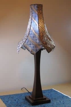 If you like crafts that upcycle neckties, follow Woof Nanny on her blog or wherever else you can find her. This beautiful and tasteful lamp is the tip of the necktie iceberg! She has a wonderfully talented eye for upcycling and sewing with neckties.