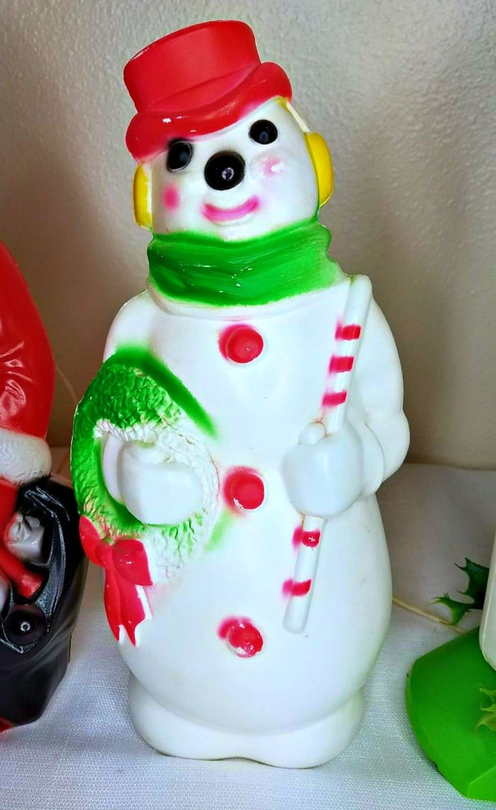 A lovely vintage 1968 Empire Plastics SNOWMAN holding his Wreath and Candy Cane, this is a mantle top indoors Blow Mold and stands thirteen inches tall.