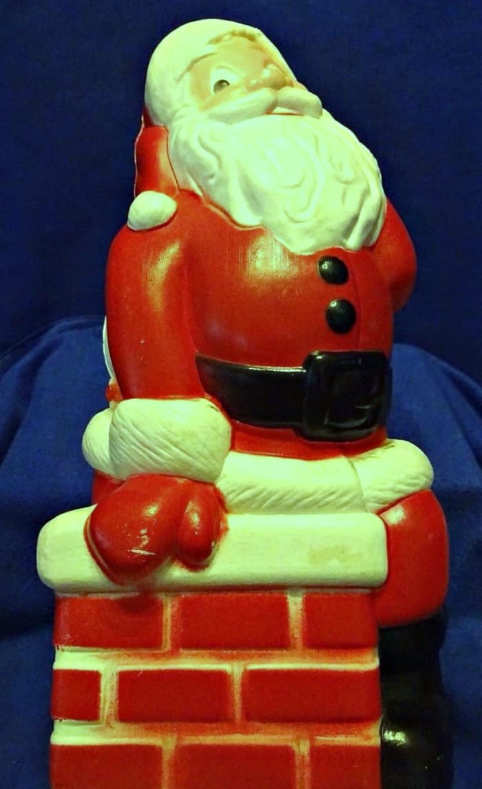 The Happy Santa Claus sitting on the chimney was made by General Foam Plastic back in the late 1960's.