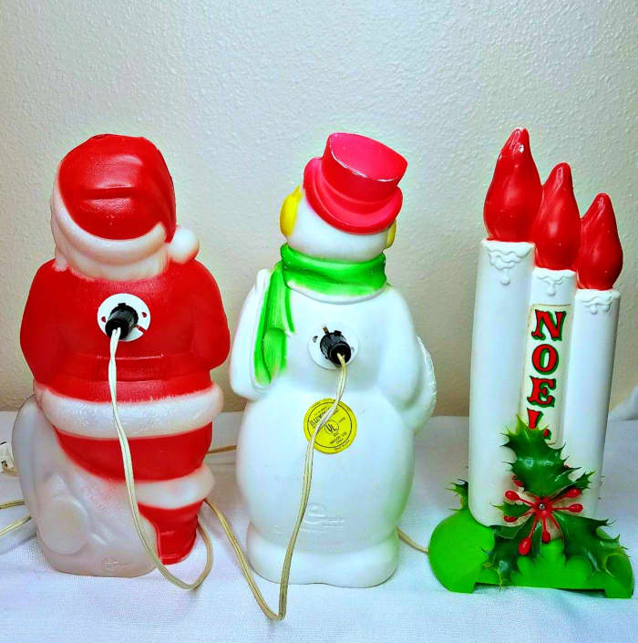 The back side of the three Empire Blow Molds made in 1968 for the Christmas Holidays. All three light up beautifully, still amazing and bright Empire Blow Mold collection is of 3 Santa Claus & Snowman Christmas 13" 14"