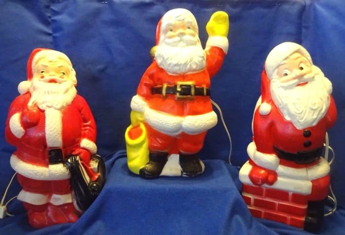 The Empire Santa has the black bag, he was made in 1968. The Santa with the yellow glove and yellow bag has no maker mark. Happy little Santa Claus sitting on the chimney is made by the world famous General Foam Plastic back in the late 1960's.