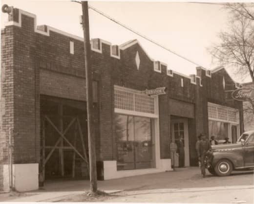Old Ford Motor Co. JV Bostic standing in the doorway. Ollie Brown leaning on the car. (Shared by Carolyn Mohr)