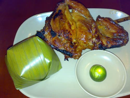 Chicken Inasal - Grilled Chicken with Steamed Rice Wrapped in Banana Leaf (Photo courtesy by whologwhy from Flickr.com)