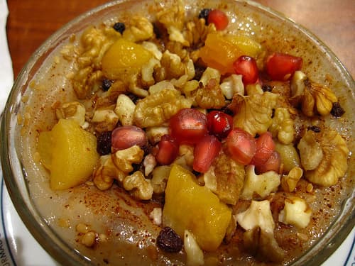 Turkish Asure topped with crushed walnuts, currants, lemon & fresh pomegranate.