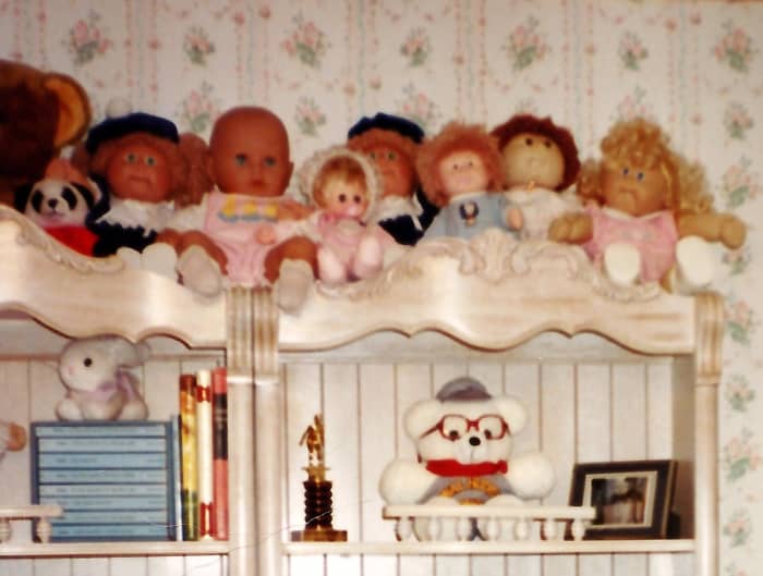 Some of my niece's collection of Cabbage Patch Kids atop some bookshelves in her bedroom back in the 1980s.