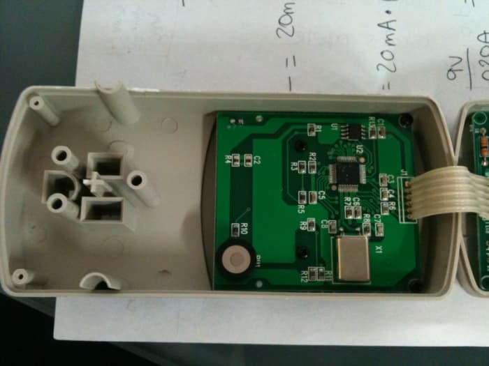 The micrcontroller board inside a watt meter. This circuit performs the logical steps to convert amps and volts to power and displays it on an LCD.
