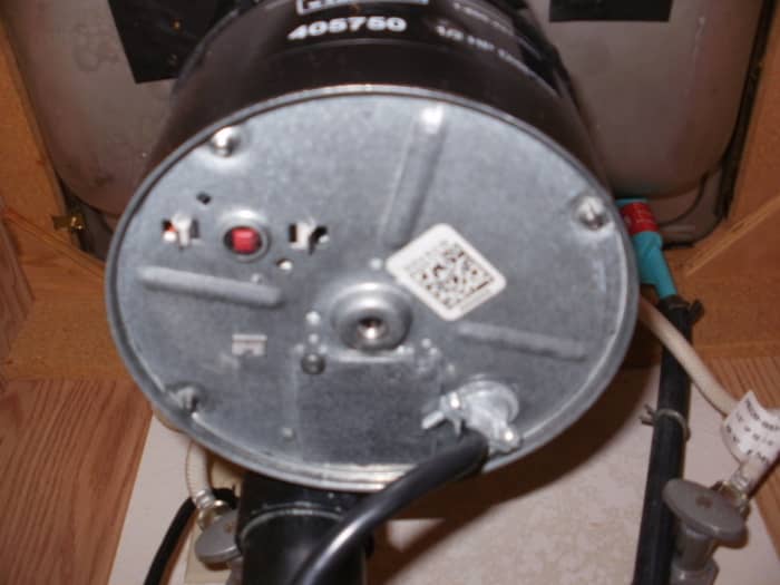 The center is the place to insert your wrench. The red button is the breaker. UNPLUG FIRST.
