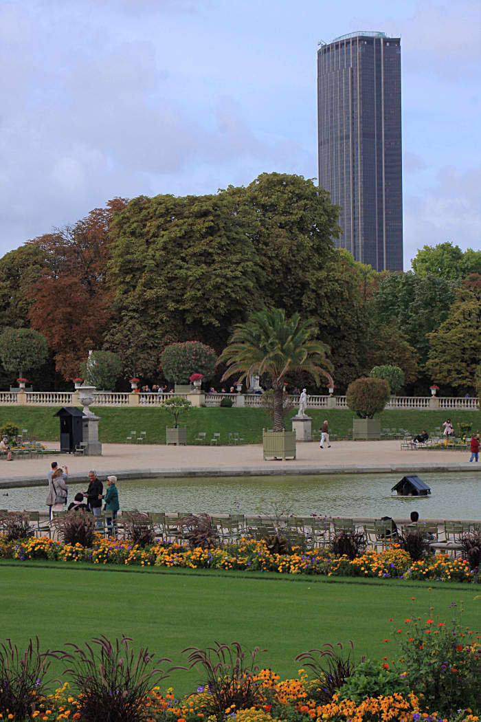 The Montparnasse Tower as seen from the Jardin du Luxembourg. The outdoor viewing platform is shielded with glass (or clear plastic?), but with ample wide gaps to allow for clear viewing and photography