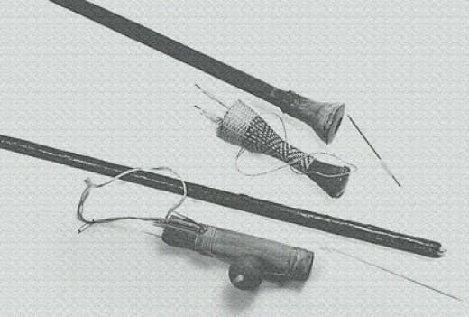 Jivaro Indian 8 ft. two-piece blowgun, darts and quiver. Gourd attach on side of quiver contains kapok which is wrapped around the rear area of the dart as an air seal. Cup also contain the curare poison.