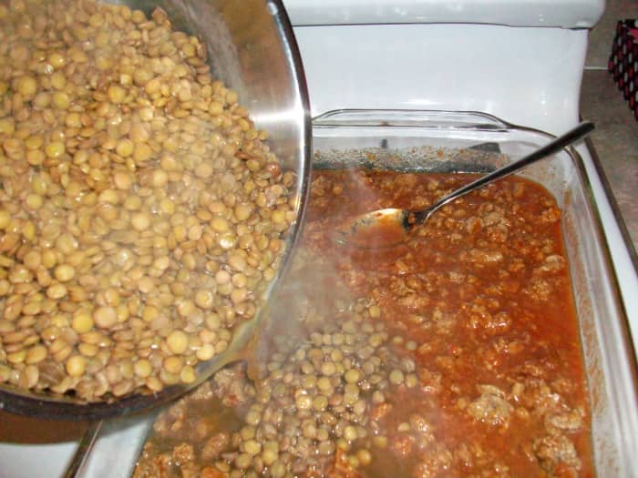 Add the hot lentils to the baking dish full of other ingredients, stir, and bake.